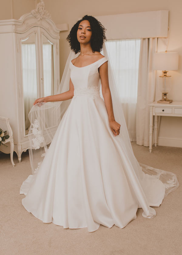 Caring: A full satin ball gown paired with Monroe belt and veil. This dress works beautifully with Nicolas separate add ons too.